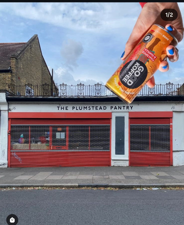 Photo of a Hand of GOOD KOFFEE Chai Spice & Vanilla in front of a photo of the outside of the Plumstead Pantry