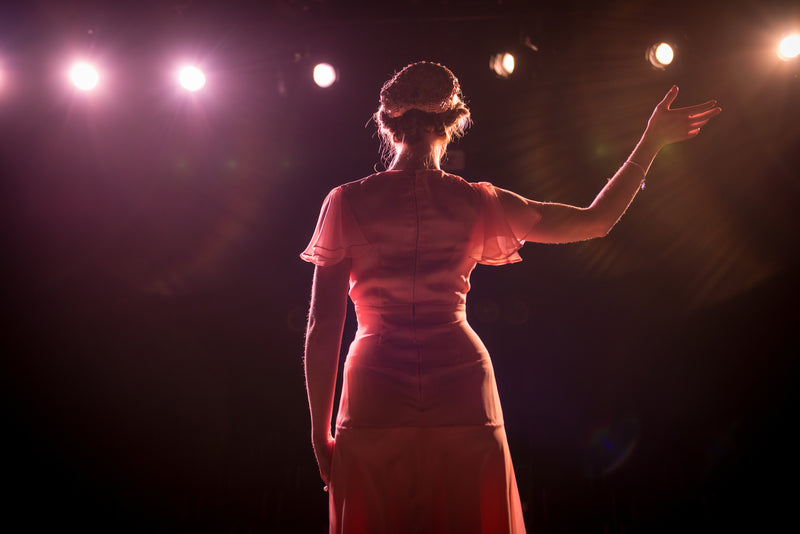 Performer on stage in theater lights